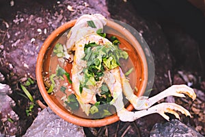 uncook chicken with thai herb in earth jar