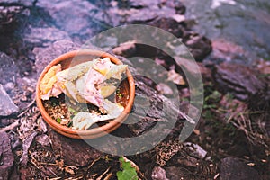 Uncook chicken with thai herb in earth jar