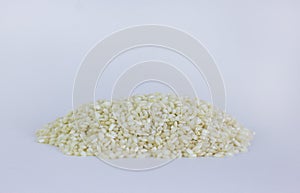 Uncooked arborio rice. Risotto rice on white background. Pile of Arborio short grain white rice isolated on white. Background of