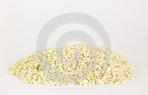 Uncooked arborio rice. Risotto rice on white background. Pile of Arborio short grain white rice isolated on white. Background of