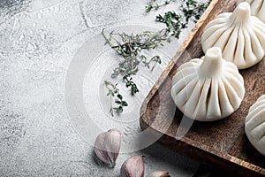 Uncooked Baozi chinese dumplings. Azian dumplings, on gray stone background, with copy space for text