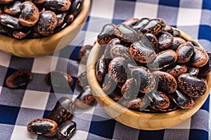 Uncooked beans in wooden bowles on kitchen table