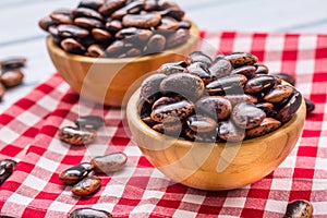 Uncooked beans in wooden bowles on kitchen table