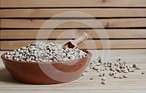 Uncooked Black Eyed Peas in Bowl on Wooden Table