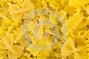 Uncooked bow tie farfalle pasta background