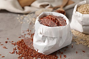 Uncooked brown rice in paper bag on table