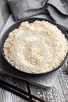 Uncooked Carnaroli risotto rice in bowl