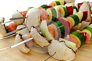 Uncooked chicken and vegetable kebabs