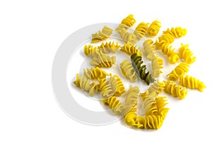 Uncooked colored pasta on a white background cocept