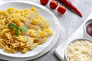 Uncooked Creste di Gallo pasta and ingredients for it cooking