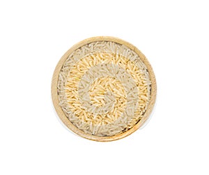 Uncooked dry Jasmine rice in wooden bowl on white background, top view