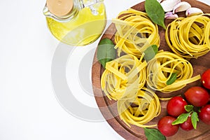 Uncooked, dry pasta Farfalle and spaghetti on a white table