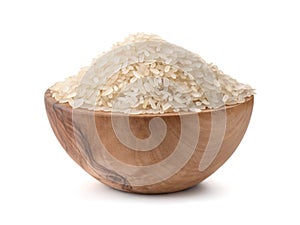 Uncooked dry rice in wooden bowl