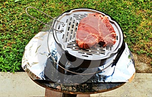 Uncooked Florentine Steak on the grill, bistecca alla fiorentina