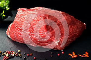 Uncooked fresh pork and beef. Raw red meat with black stone background and spices