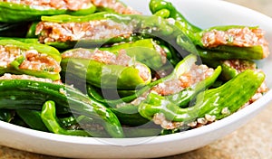 Uncooked Fresh Stuffed Green Peppers ready for cooking