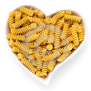 Uncooked fusilli pasta isolated white background.