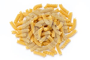 Uncooked fusilli pasta isolated white background.