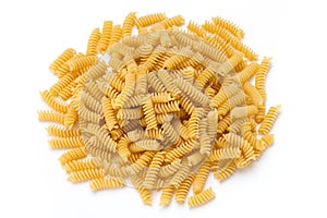 Uncooked fusilli pasta isolated white background.