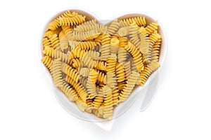 Uncooked fusilli pasta isolated white background.