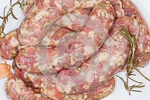 Uncooked homemade pork sausages and spices, top view close-up