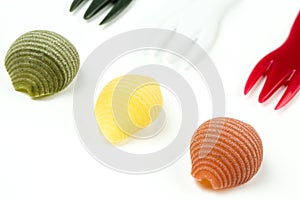 Uncooked Italian conchiglie pasta on a white background