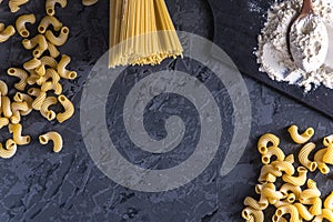 Uncooked italian pasta spaghetti and cavatappi with flour from durum wheat. Concept of The composition of food design.