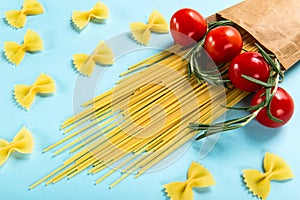 Uncooked Italian Pasta Spaghetti and farfalle rigate with cherry and rosemary