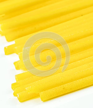 Uncooked Italian spaghetti on a white background