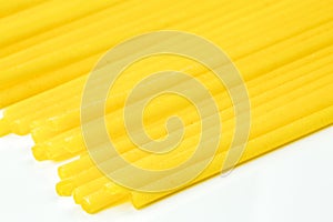 Uncooked Italian spaghetti on a white background