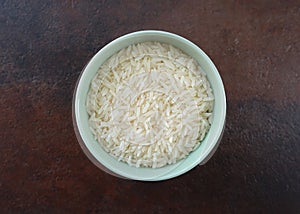 Uncooked Jasmine Rice in a Green Bowl