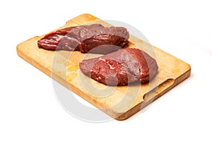 Uncooked Kangaroo meat steaks on cutting board