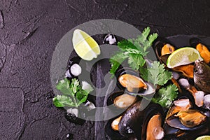 Uncooked mussels on ice with cilantro and coriander