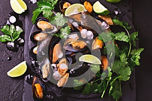 Uncooked mussels on ice with cilantro and coriander