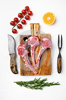 Uncooked mutton rack of lamb, on white stone table background, top view flat lay