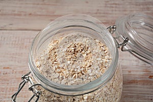 Uncooked oatmeal in  a bowl on the table.