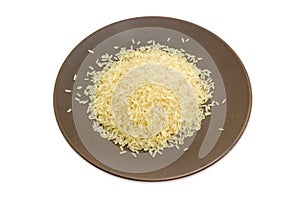 Uncooked parboiled rice on the brown dish