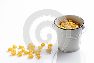 uncooked pasta in bucket on a white background
