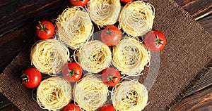 Uncooked pasta bunches and tomatoes