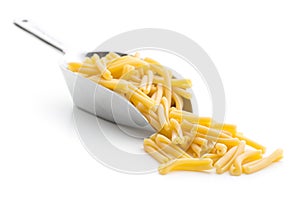 Uncooked pasta caserecce in metal scoop