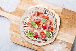 Uncooked pizza dough with toppings