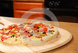 Uncooked pizza on peel