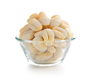 Uncooked potato gnocchi in bowl isolated on white background