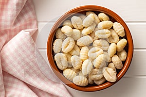 Uncooked potato gnocchi in bowl. Tasty italian food