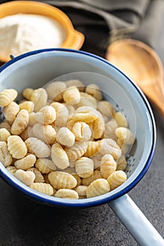 Uncooked potato gnocchi in colander. Tasty italian food