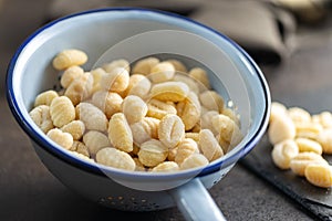 Uncooked potato gnocchi in colander. Tasty italian food