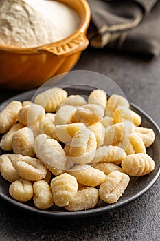 Uncooked potato gnocchi on plate. Tasty italian food