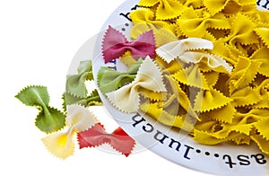 Uncooked rainbow farfalle pasta on plate