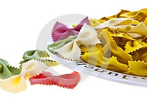 Uncooked rainbow farfalle pasta on plate