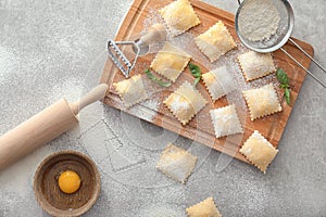 Uncooked ravioli on grey table